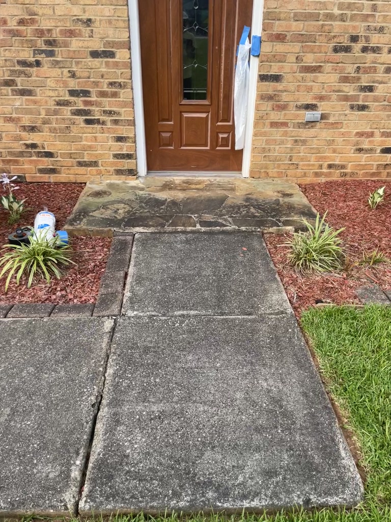 Before wash: same Stone Mountain entryway and hardscape needing cleaning